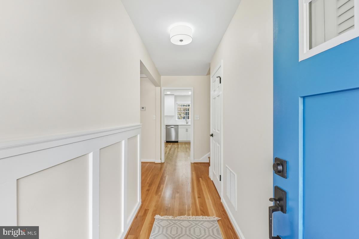 1203 Brantford Avenue Silver Spring, MD 20904 - Photo 13 of 32 a view of a hallway with wooden floor and staircase