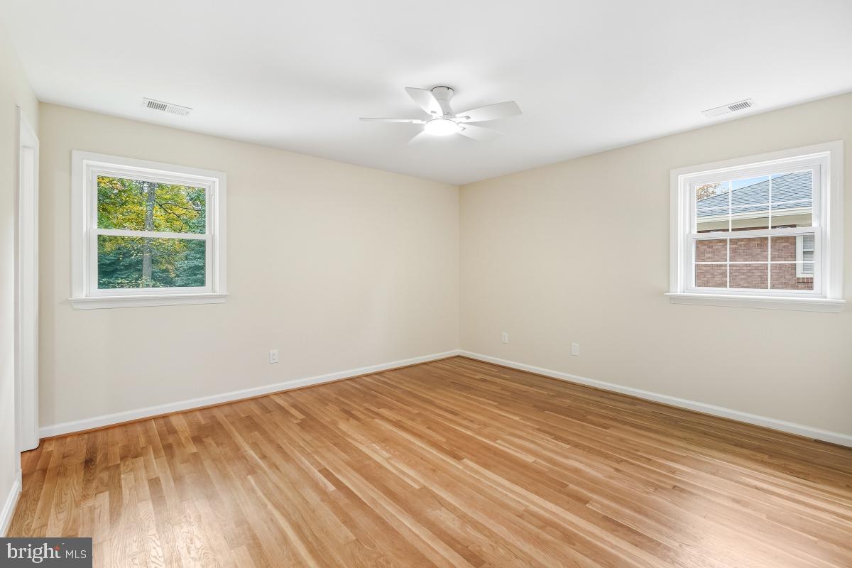 1203 Brantford Avenue Silver Spring, MD 20904 - Photo 14 of 32 a view of an empty room with wooden floor and a window