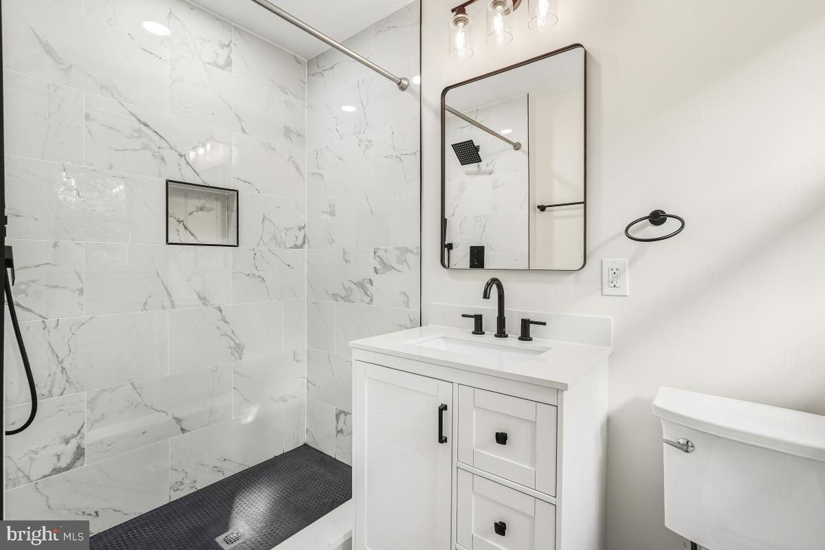 1203 Brantford Avenue Silver Spring, MD 20904 - Photo 16 of 32 a bathroom with a sink a toilet and shower