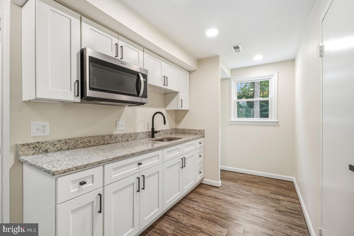 1203 Brantford Avenue Silver Spring, MD 20904 - Photo 20 of 32 a kitchen with stainless steel appliances granite countertop a sink and a microwave oven