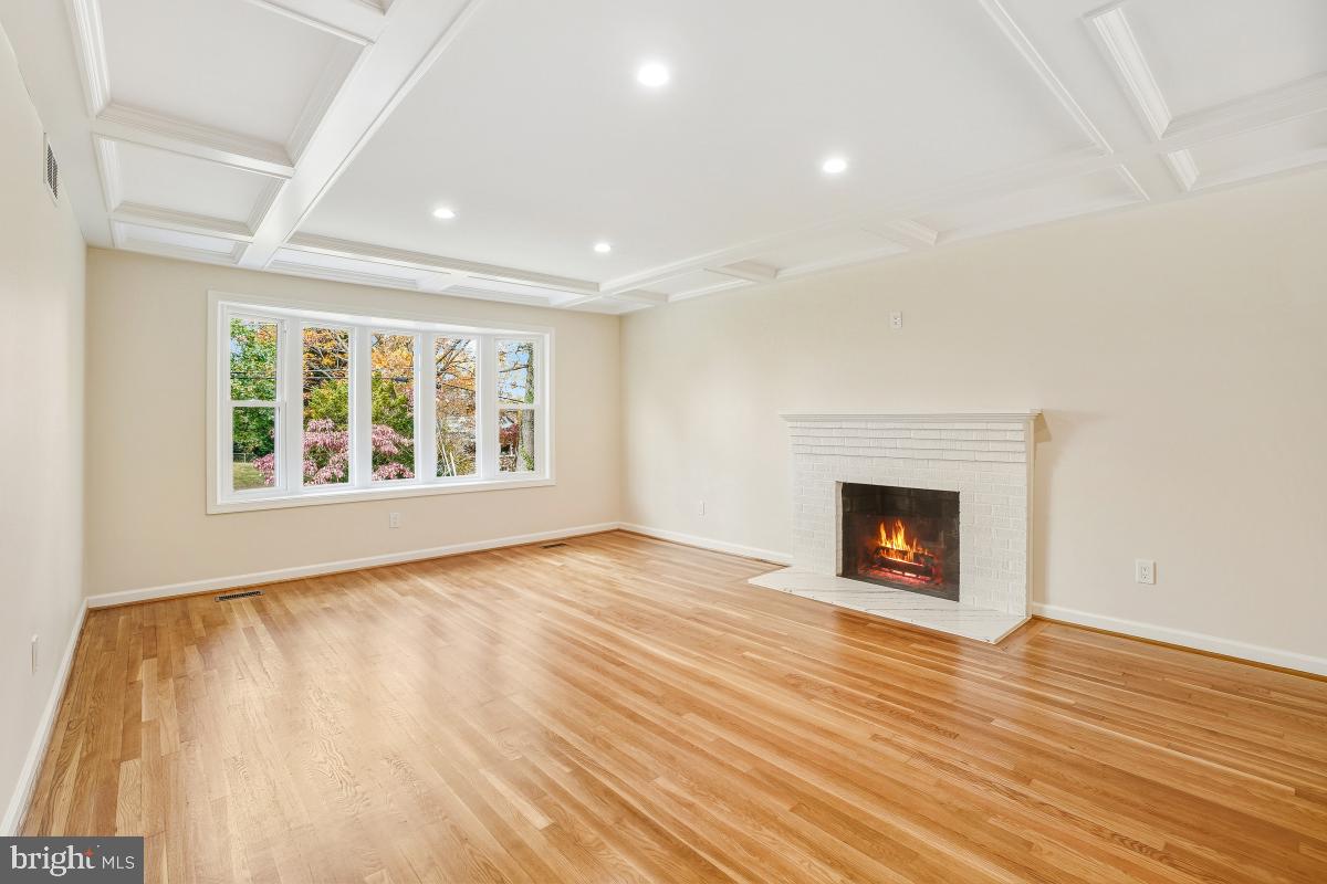 1203 Brantford Avenue Silver Spring, MD 20904 - Photo 2 of 32 a view of empty room with wooden floor and fireplace