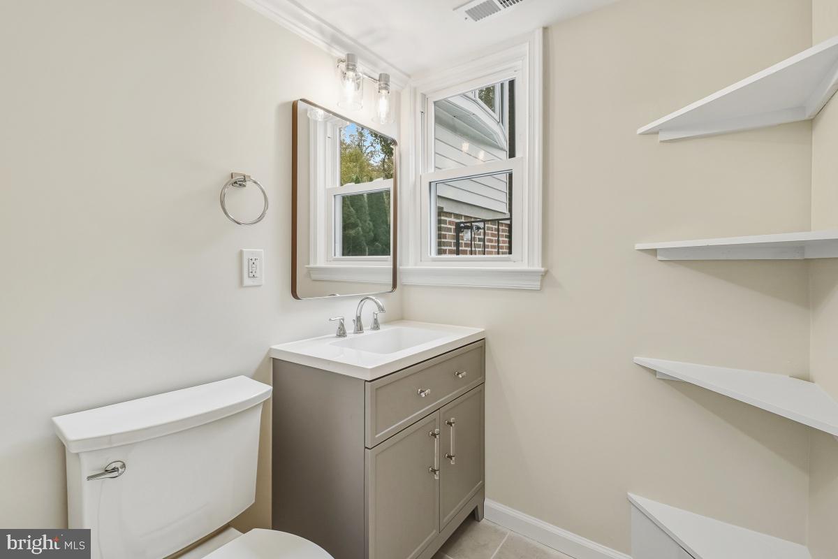 1203 Brantford Avenue Silver Spring, MD 20904 - Photo 21 of 32 a bathroom with a toilet sink vanity and mirror