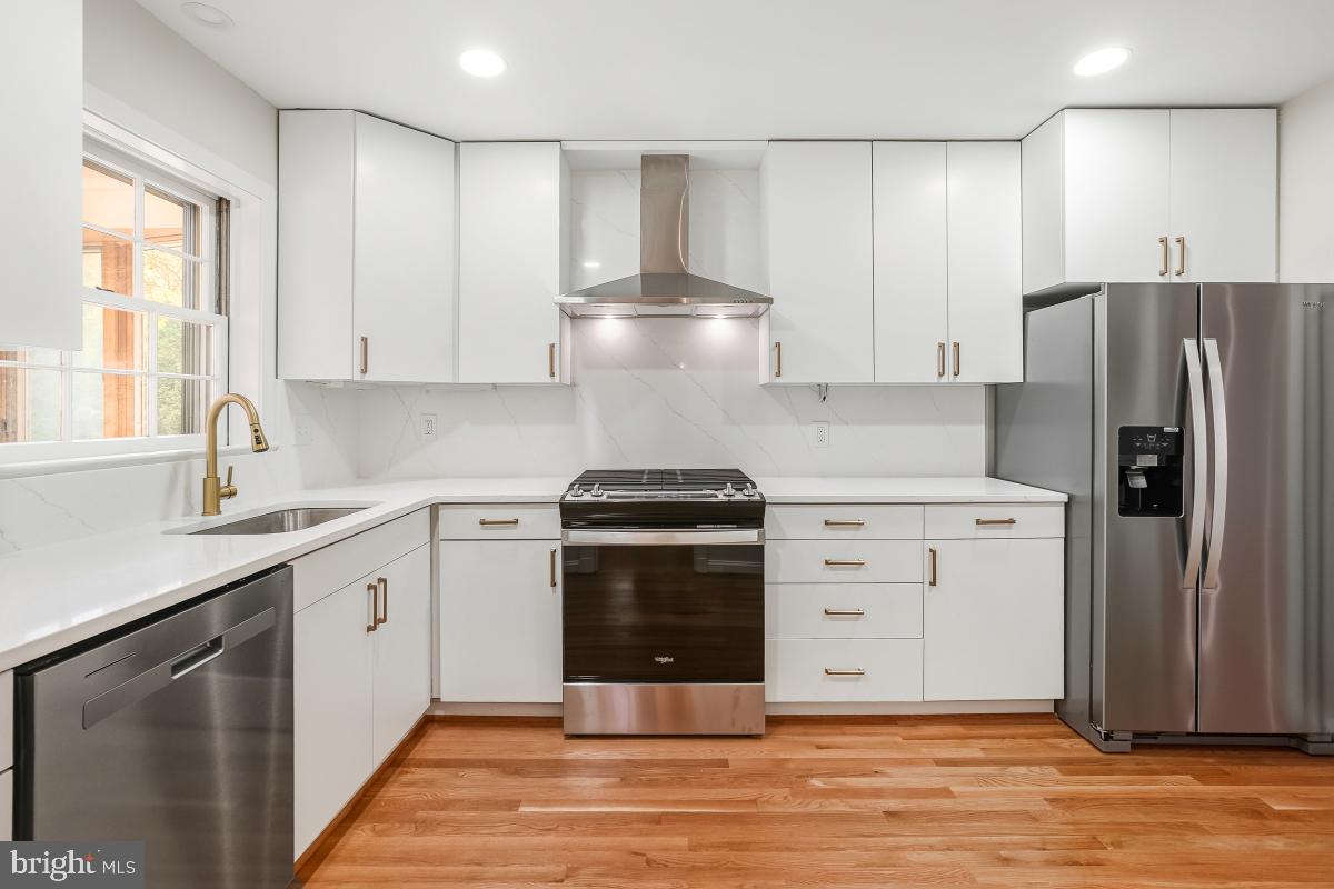 1203 Brantford Avenue Silver Spring, MD 20904 - Photo 4 of 32 a kitchen with a stove cabinets and wooden floor