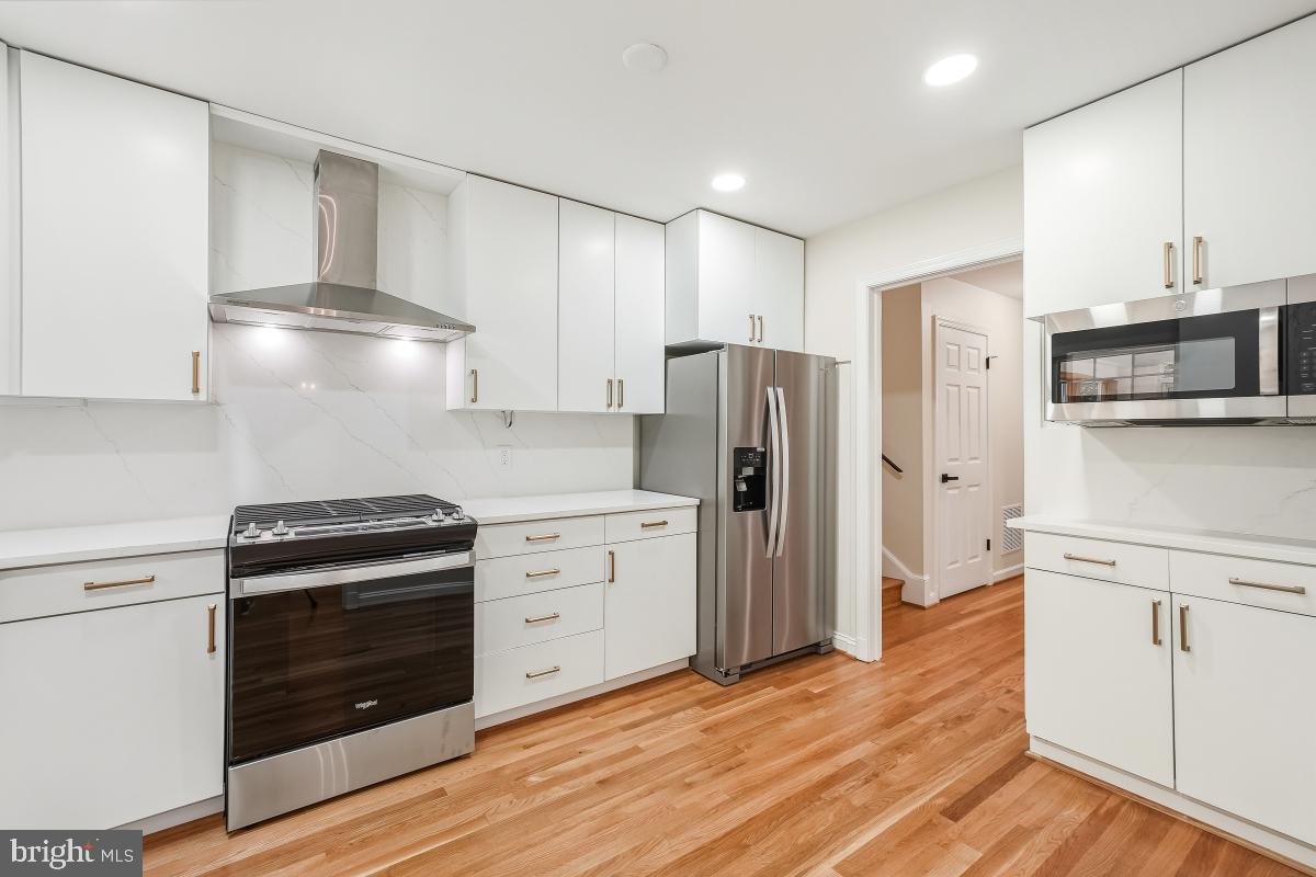 1203 Brantford Avenue Silver Spring, MD 20904 - Photo 10 of 32 a kitchen with stainless steel appliances a stove a refrigerator and cabinets