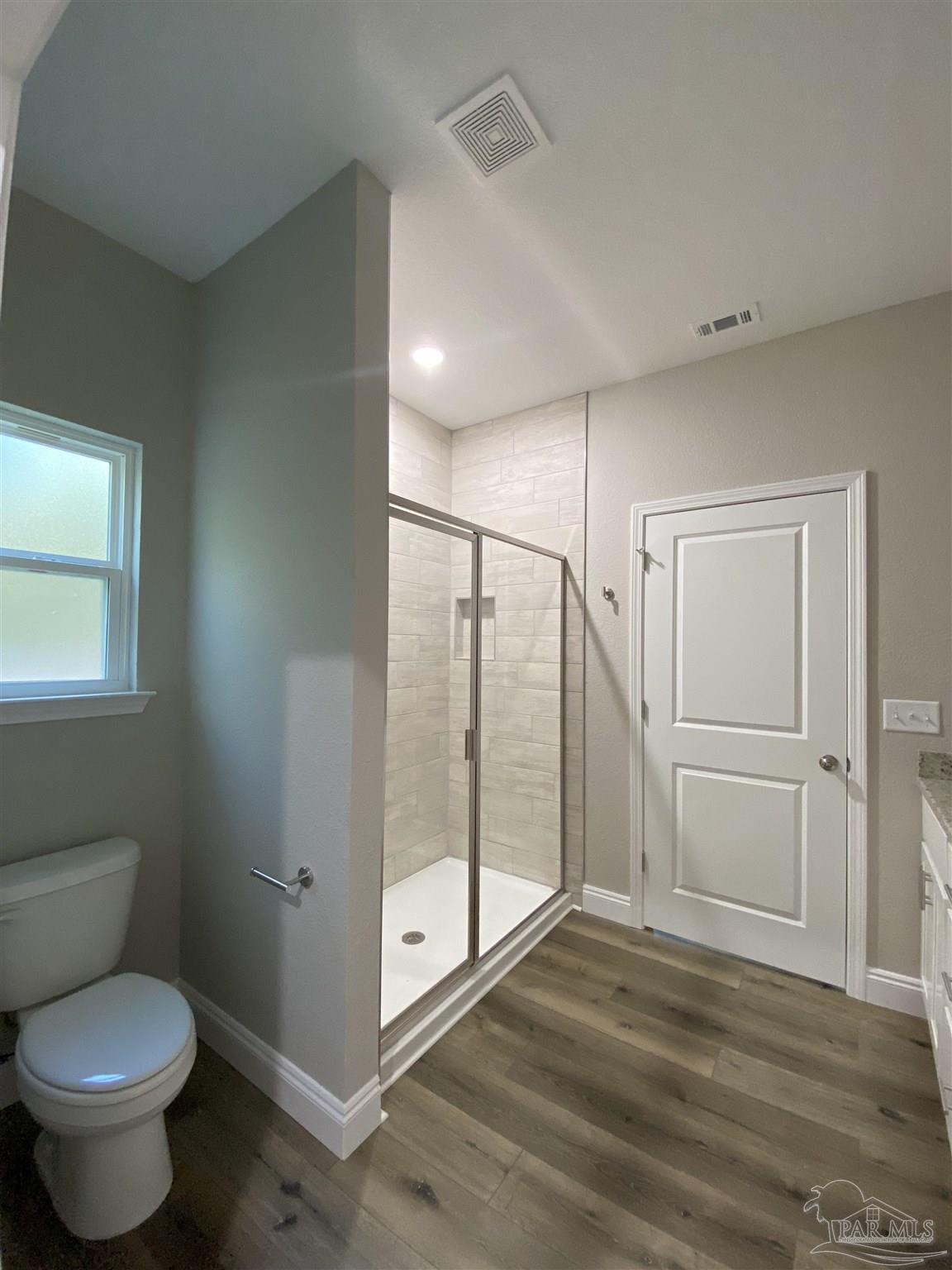 6768 Contentment Street Milton, FL 32583 - Photo 15 of 21 a bathroom with a toilet and a shower