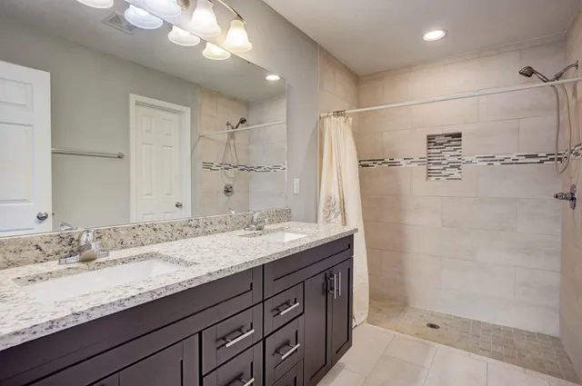 a bathroom with a granite countertop sink mirror and double