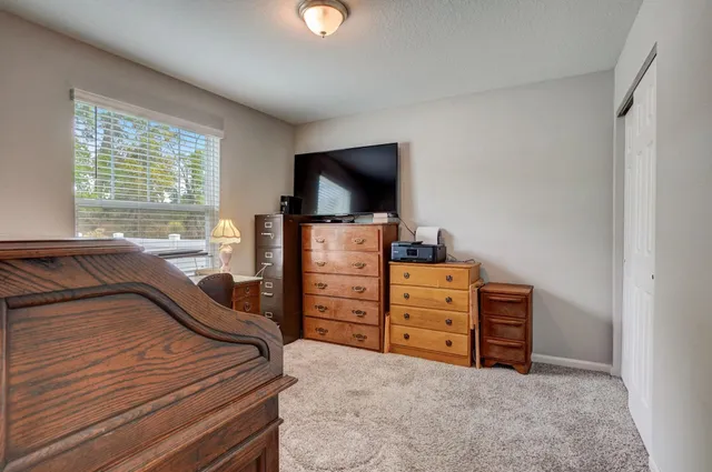 a bedroom with a bed and flat screen tv
