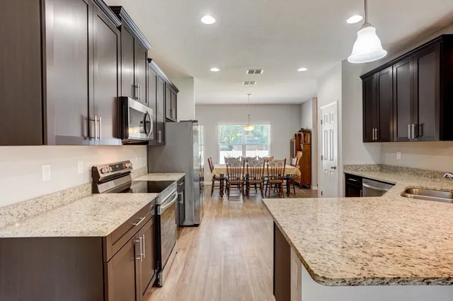 a kitchen with stainless steel appliances granite countertop counter space a sink and cabinets