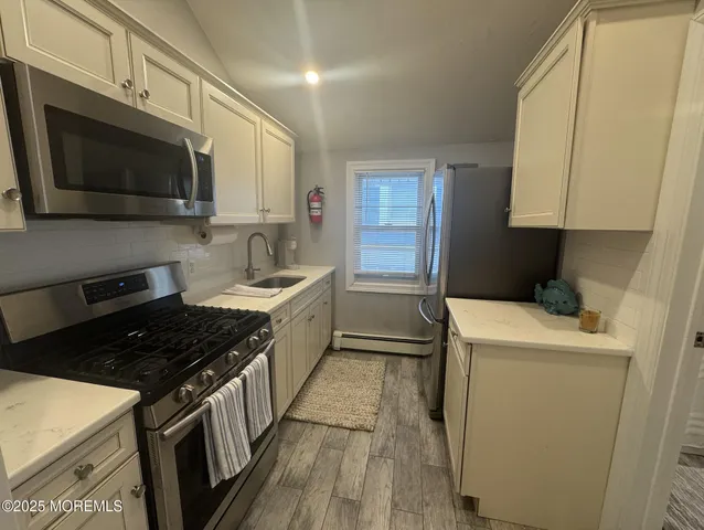 a kitchen with a sink stove and microwave