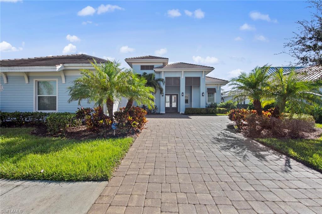 a view of a patio with table and chairs potted plants and large tree