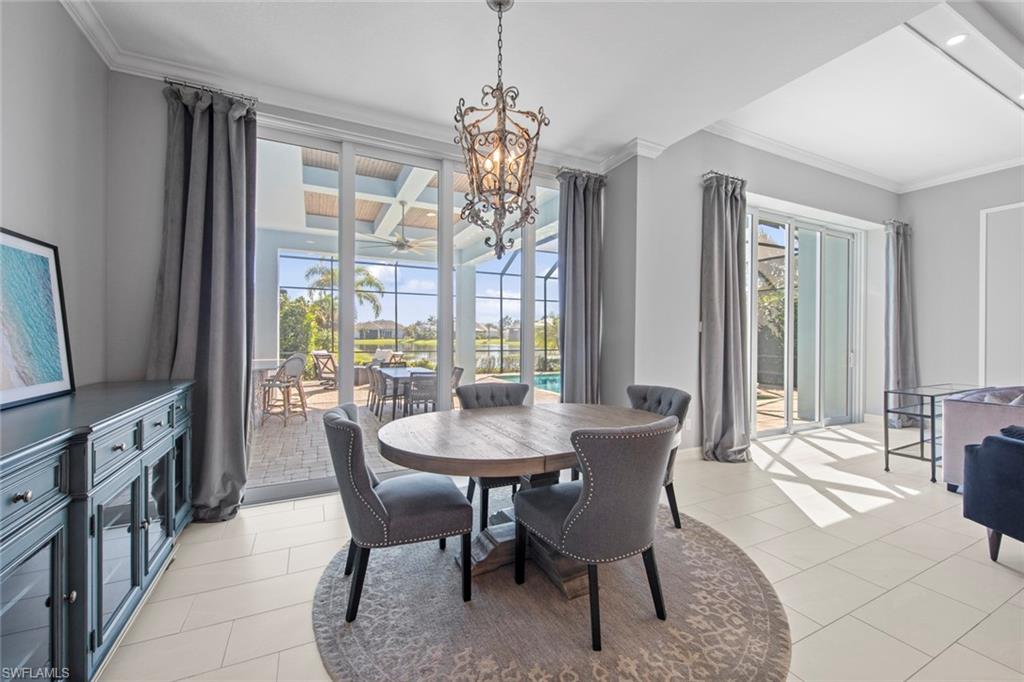 14792 Spinnaker Way Naples, FL 34114 - Photo 13 of 48 a dining room with furniture a chandelier and wooden floor