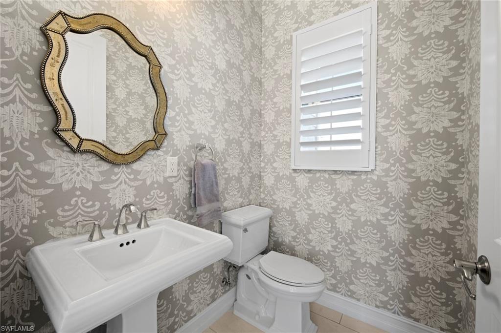 14792 Spinnaker Way Naples, FL 34114 - Photo 15 of 48 a bathroom with a sink a toilet and a mirror