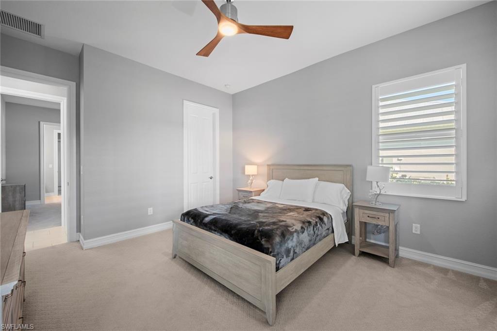 14792 Spinnaker Way Naples, FL 34114 - Photo 21 of 48 a spacious bedroom with a bed and a window