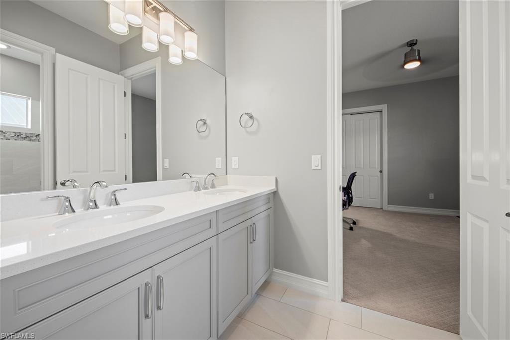 14792 Spinnaker Way Naples, FL 34114 - Photo 24 of 48 a spacious bathroom with a double vanity sink a mirror and shower