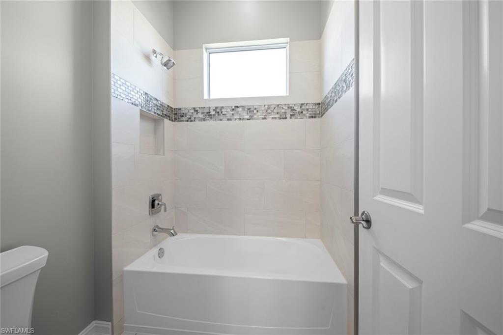 14792 Spinnaker Way Naples, FL 34114 - Photo 26 of 48 a bathroom with a shower and a bathtub