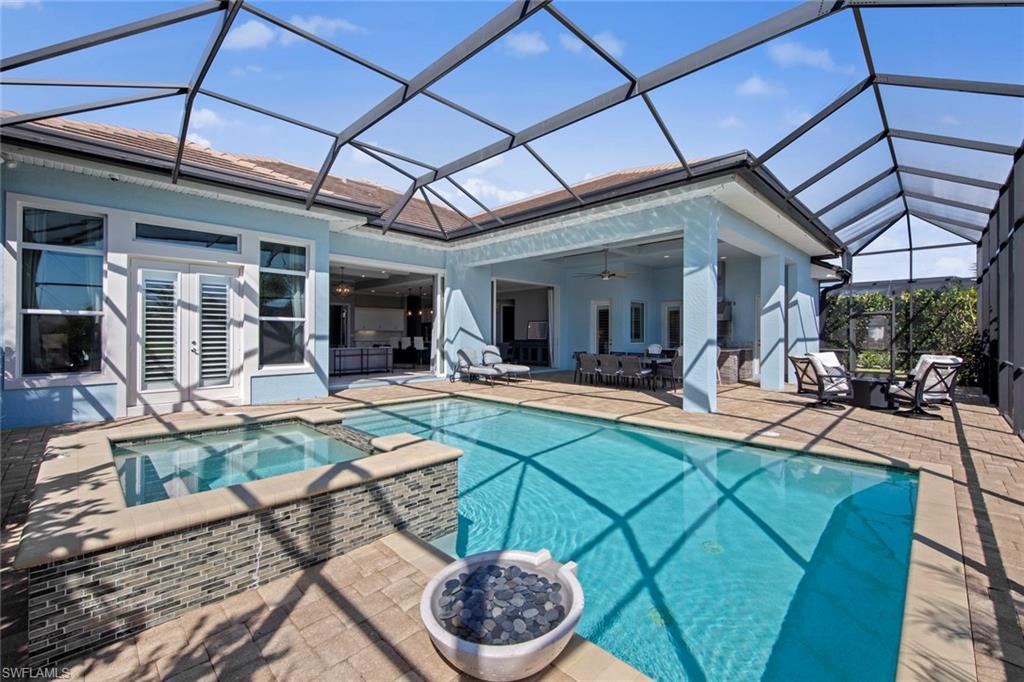 14792 Spinnaker Way Naples, FL 34114 - Photo 29 of 48 a view of a backyard with table and chairs under an umbrella