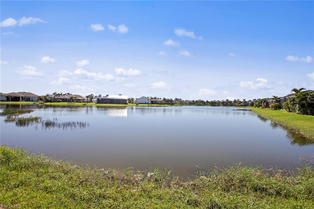 14792 Spinnaker Way Naples, FL 34114 - Photo 3 of 48 a view of a lake with houses in the back