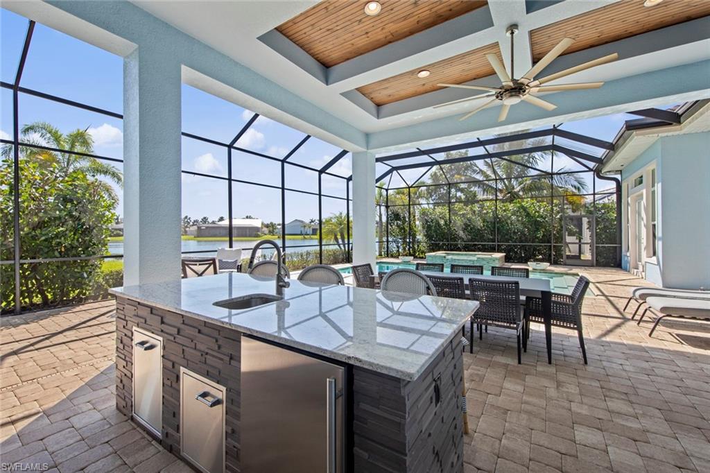 14792 Spinnaker Way Naples, FL 34114 - Photo 33 of 48 a outdoor space with lots of tables a garden view and chairs