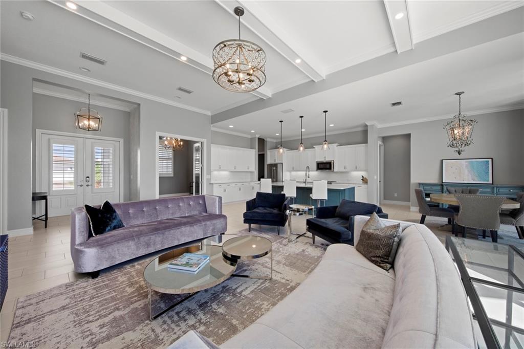 14792 Spinnaker Way Naples, FL 34114 - Photo 5 of 48 a living room with furniture or couch and a chandelier