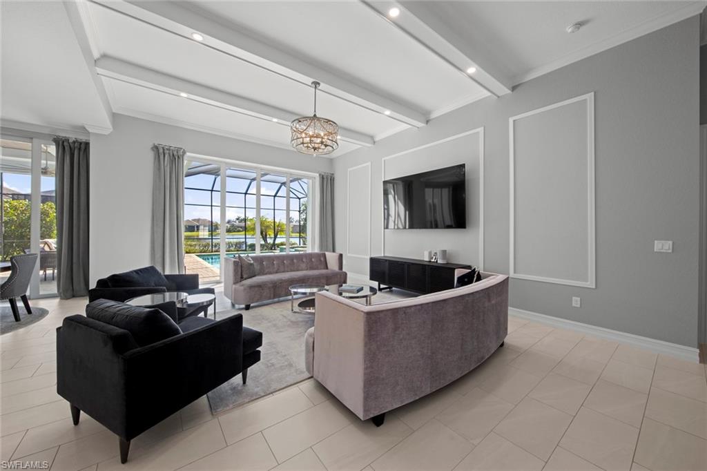 14792 Spinnaker Way Naples, FL 34114 - Photo 7 of 48 a living room with furniture and a flat screen tv