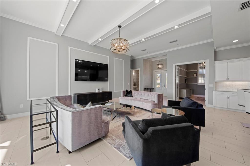 14792 Spinnaker Way Naples, FL 34114 - Photo 8 of 48 a living room with furniture and a flat screen tv