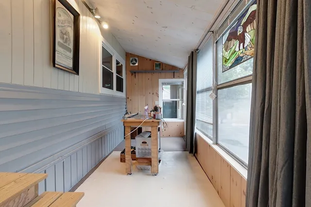 a dining room with furniture and a window