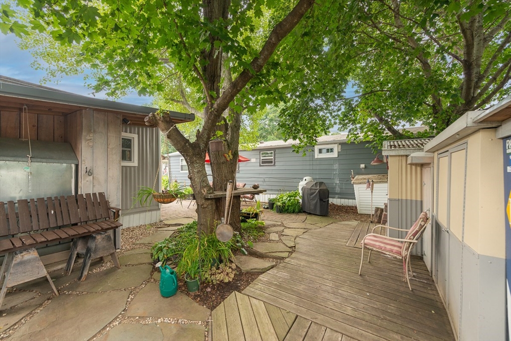 239 Ayer Road, Unit 16 Littleton, MA 01460 - Photo 19 of 22 a view of a house with backyard and sitting area