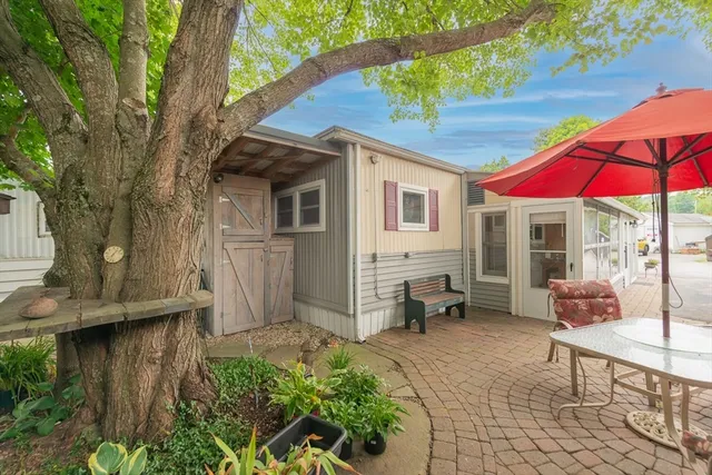 a view of a house with backyard and sitting area