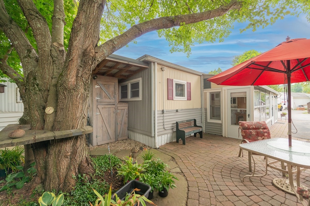 239 Ayer Road, Unit 16 Littleton, MA 01460 - Photo 2 of 22 a view of a house with backyard and sitting area