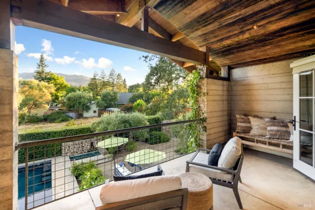 a view of a chair and tables in the balcony