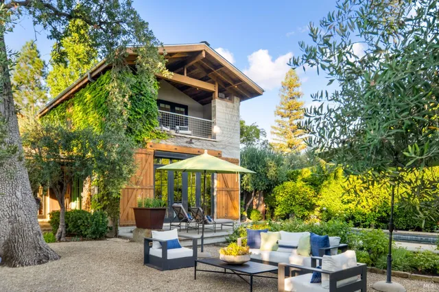a backyard of a house with table and chairs