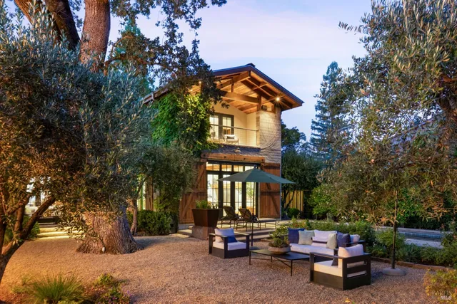 a backyard of a house with outdoor seating