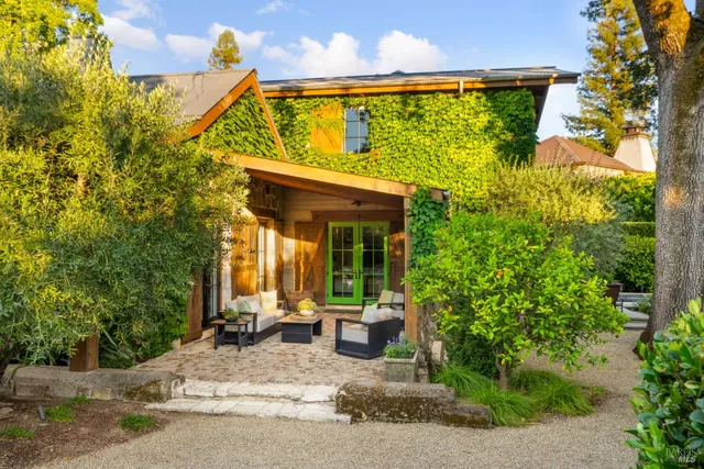 a view of a house with garden and sitting area