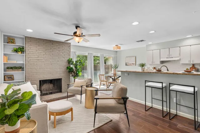 a living room with furniture fireplace and dining room