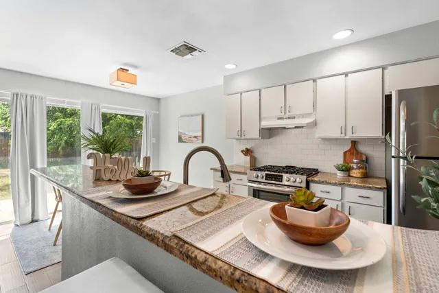 a kitchen with a stove a sink and a refrigerator