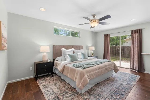 a bedroom with a large bed and a chandelier