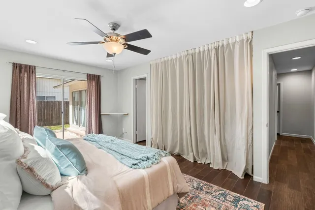a bedroom with a large bed and a chandelier