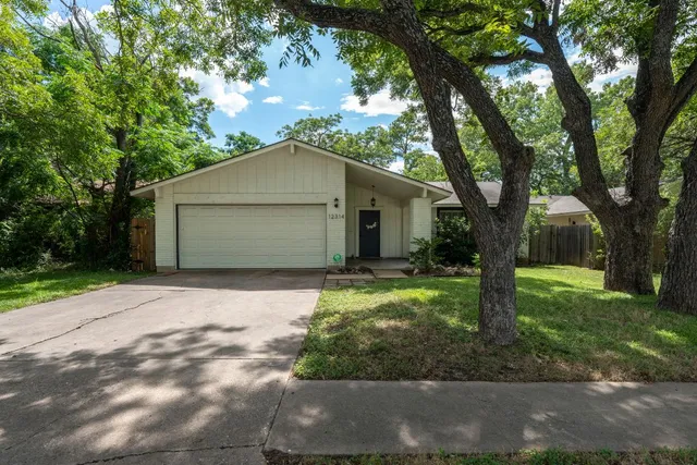 a front view of house with a garden