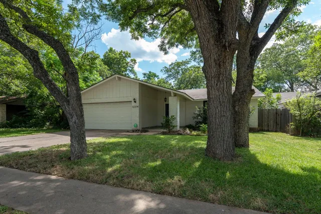 a house that has tree in front of it