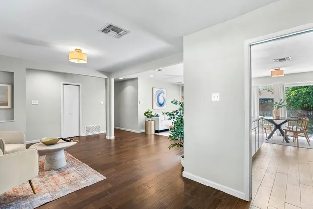 a living room with furniture and wooden floor