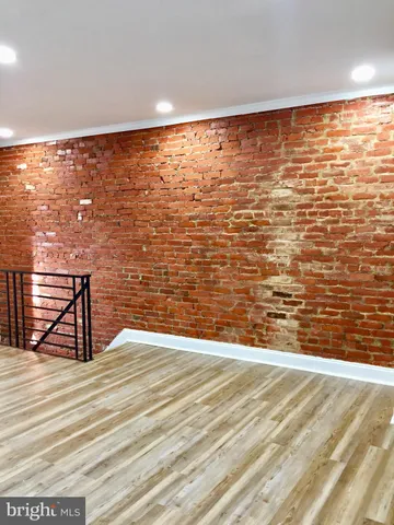 a kitchen with stainless steel appliances wooden floor a refrigerator and a stove