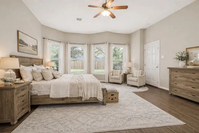 a spacious bedroom with a bed and large windows