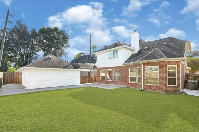a front view of a house with a yard and lake view