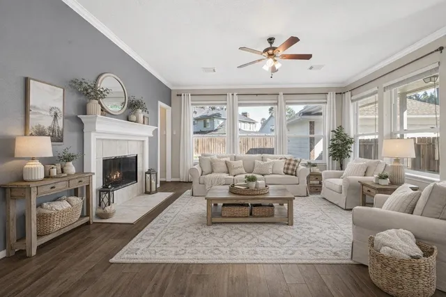 a living room with furniture fireplace and a large window