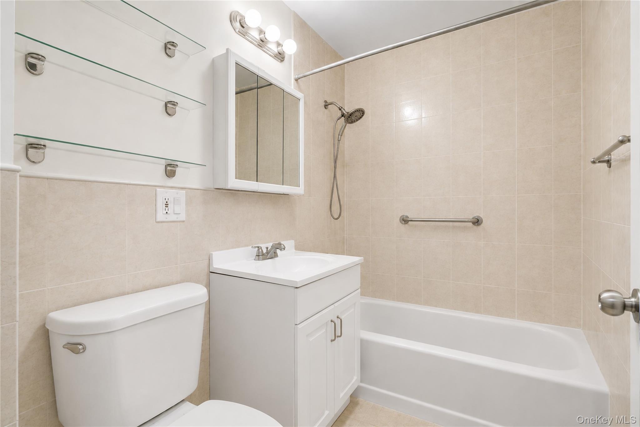 58-03 Calloway Street, Unit 5A Queens, NY 11368 - Photo 14 of 19 a bathroom with a sink a toilet and shower