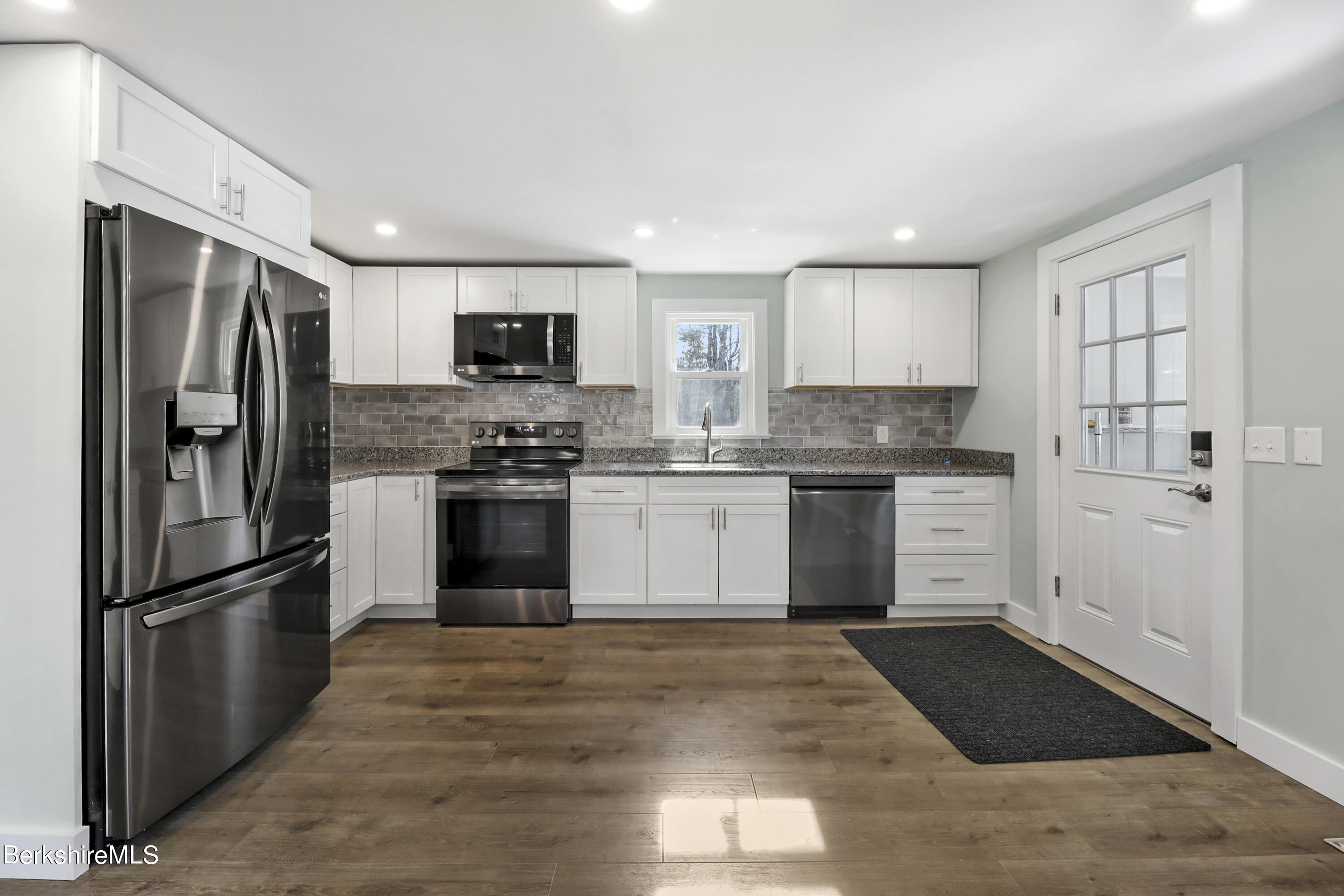 1130 Middle Road Clarksburg, MA 01247 - Photo 13 of 28 a kitchen with granite countertop a refrigerator and a stove top oven