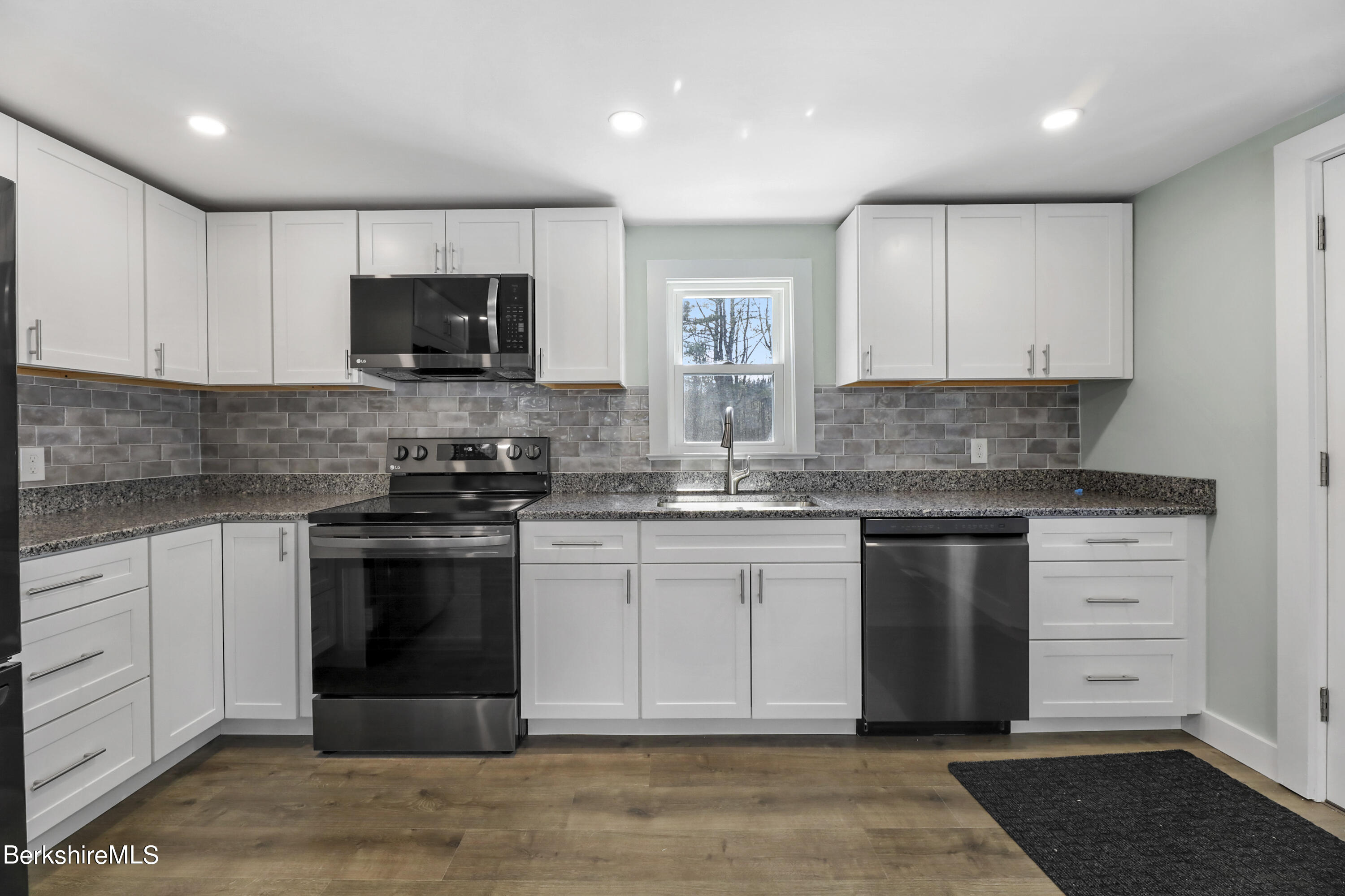 1130 Middle Road Clarksburg, MA 01247 - Photo 14 of 28 a kitchen with stainless steel appliances granite countertop a stove a sink and a microwave