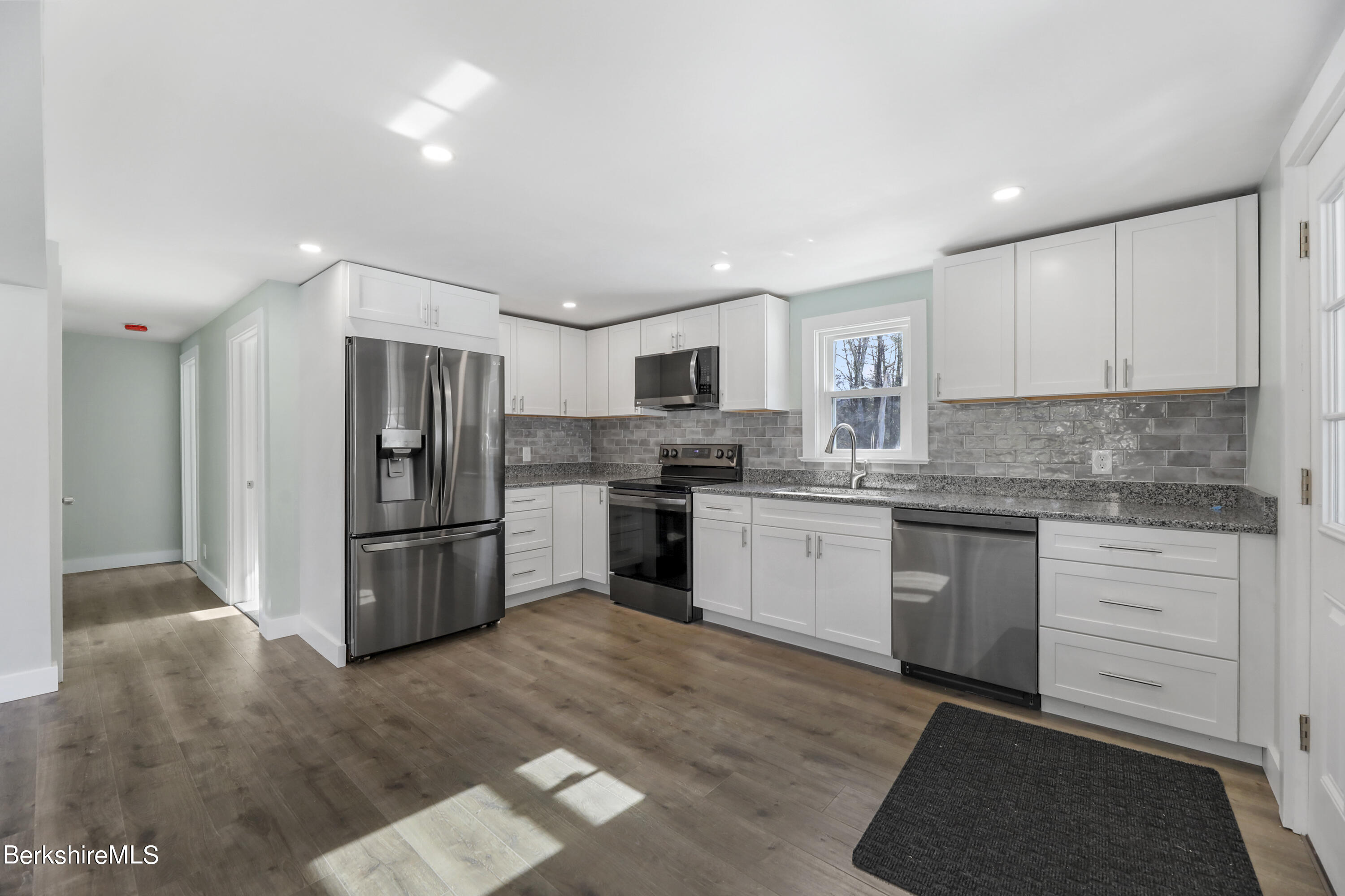 1130 Middle Road Clarksburg, MA 01247 - Photo 15 of 28 a kitchen with a refrigerator and white cabinets