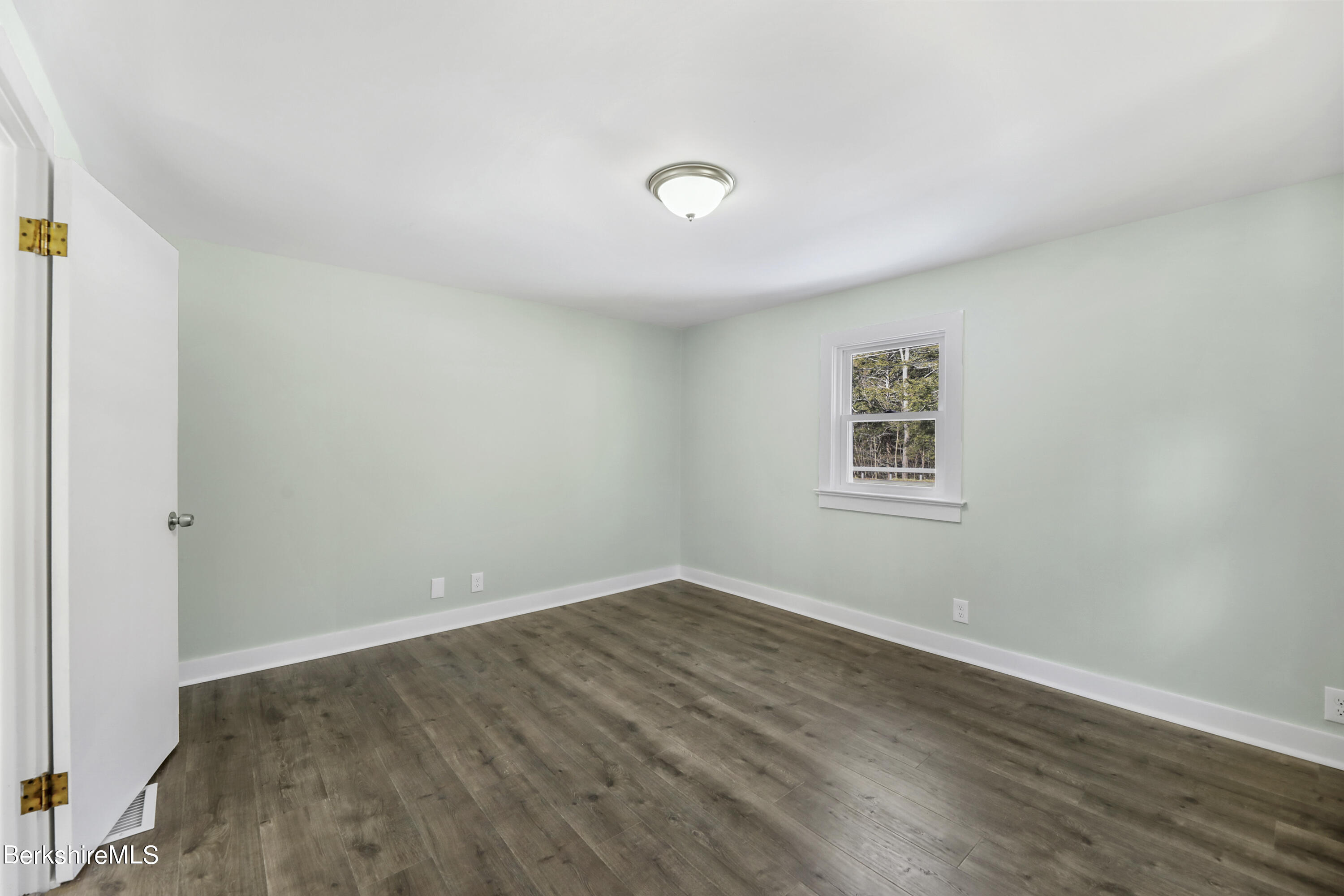 1130 Middle Road Clarksburg, MA 01247 - Photo 16 of 28 an empty room with wooden floor and windows