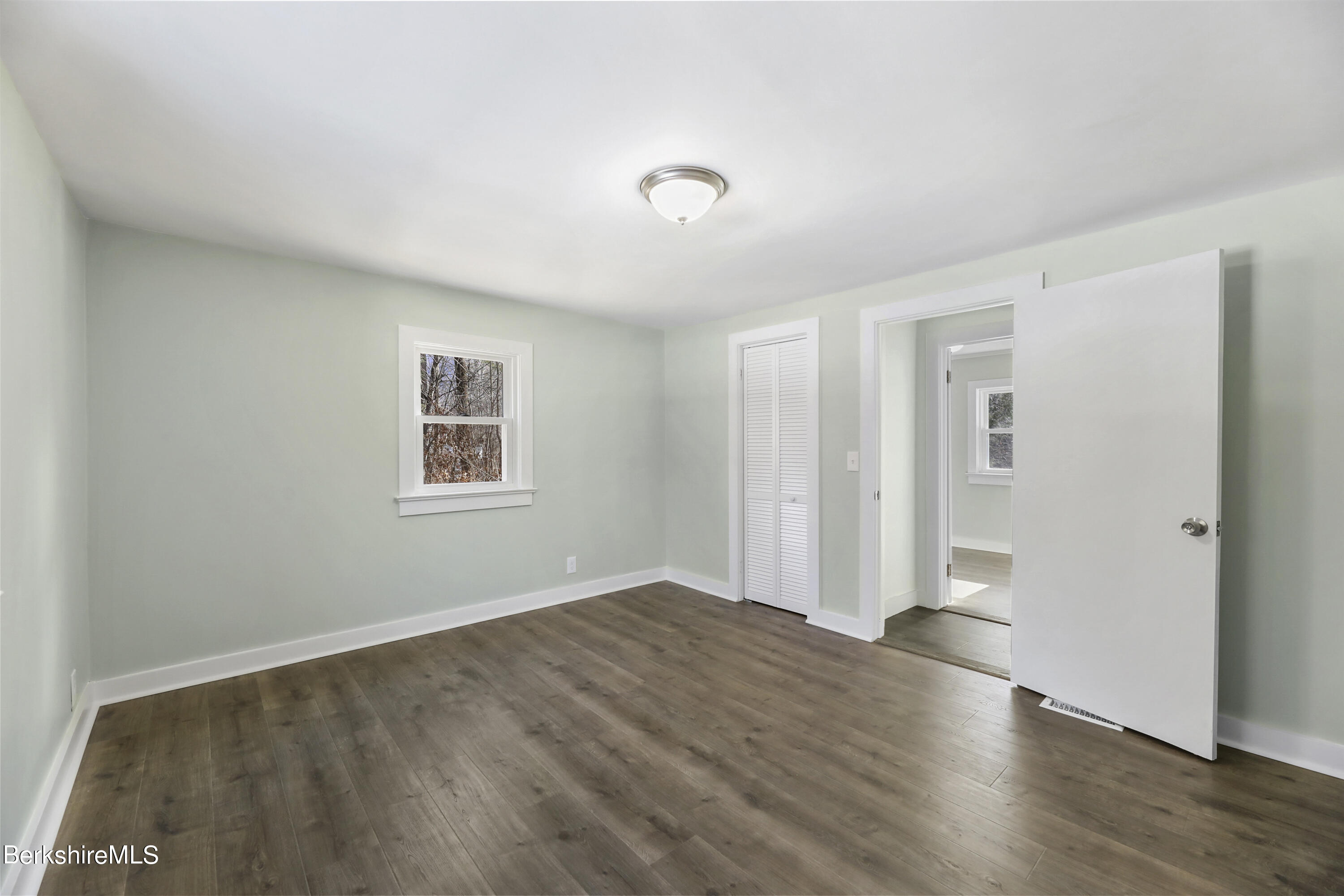 1130 Middle Road Clarksburg, MA 01247 - Photo 18 of 28 a view of an empty room with wooden floor and a window